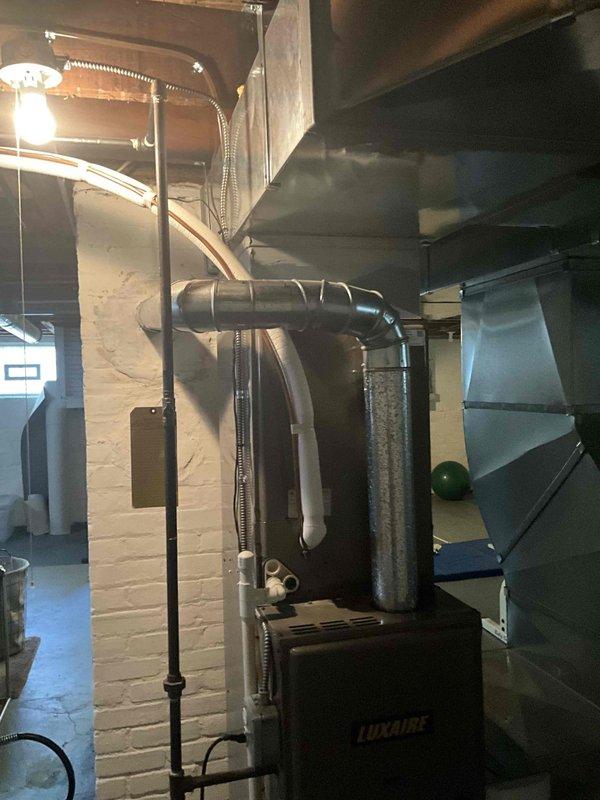 Responded to no cooling complaint on residential split system. Upon arrival, evaluated existing Luxaire outdoor condensing unit and indoor air handler for system failure. Conducted comprehensive assessment of equipment condition, refrigerant lines, electrical connections, and overall system performance. Documented current installation including outdoor unit on gravel pad with refrigerant lines and electrical conduit routing, and basement-mounted indoor equipment with ductwork connections. Prepared detailed replacement estimate for complete HVAC system upgrade to restore cooling capacity and ensure reliable operation.