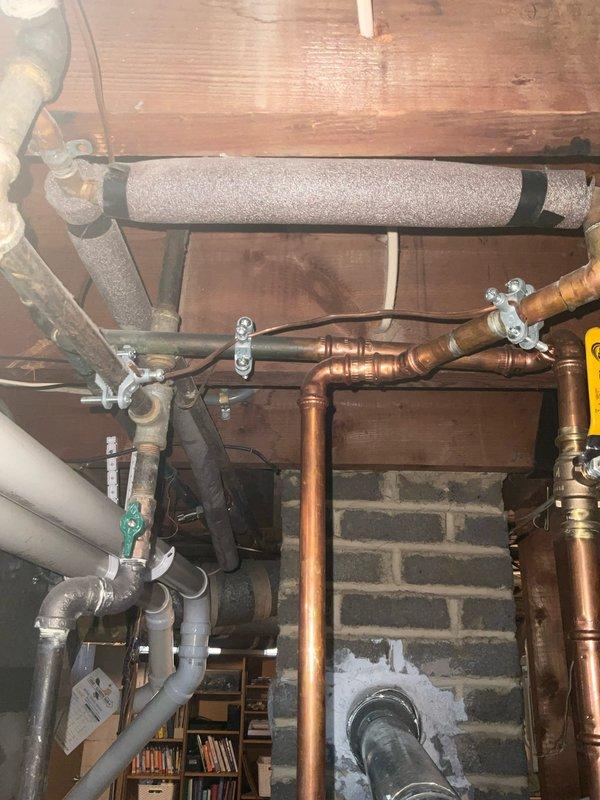 Completed comprehensive whole-home plumbing assessment identifying multiple areas requiring attention. Inspected basement mechanical systems including copper supply lines, PVC drainage piping, pipe insulation, and support brackets mounted to floor joists. Evaluated bathroom plumbing fixtures including tub/shower valve assembly, spout, and overflow components. Documented all findings with photographs for customer review and provided recommendations for necessary repairs and improvements.