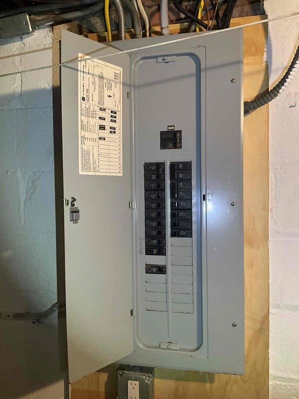 Conducted site assessment for mini split installation in upper-level bedroom with slanted ceiling and evaluated existing electrical panel capacity in basement utility area. Reviewed multiple installation options with homeowner, who requested time to discuss before proceeding with equipment selection and final system configuration.