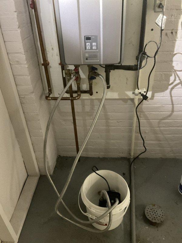 Performed routine descaling maintenance on a tankless water heater unit over 10 years old as part of a recurring home plan service. Connected descaling pump with circulation hoses to flush the heat exchanger using appropriate descaling solution to remove mineral buildup and maintain optimal unit performance. Verified proper hot water flow and temperature at fixtures upon completion of the flush procedure.