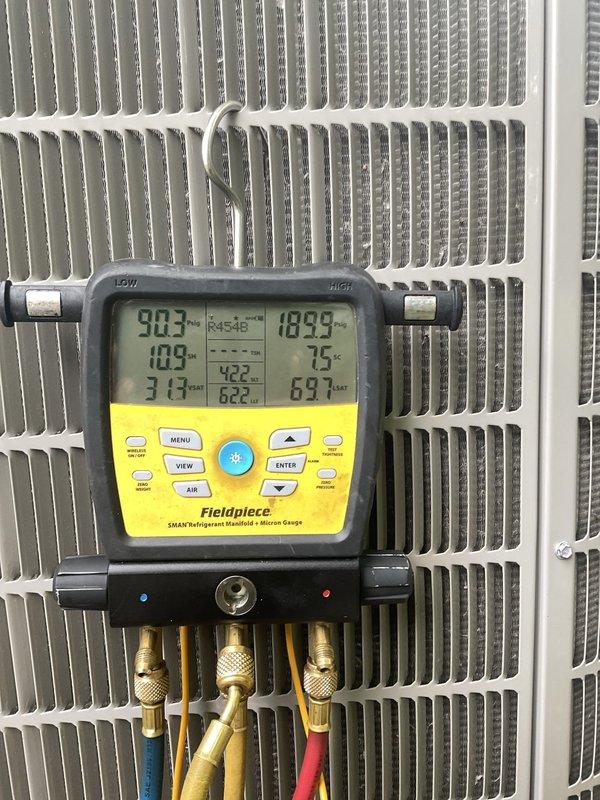 Responded to no-cooling complaint on 2-month-old air conditioning system that has not functioned properly since installation. Performed comprehensive diagnostic evaluation using digital manifold gauges to measure refrigerant pressures, temperatures, and superheat/subcooling values at outdoor condensing unit. Assessed system charge levels and operational parameters. Evaluated indoor furnace unit in basement using digital thermometer probe to verify temperature differentials and airflow compatibility between 14-year-old gas furnace and new AC system. Inspected thermostat programming and wiring configuration to identify potential communication issues between components. Documented system performance with diagnostic readings and photographic evidence of equipment conditions.