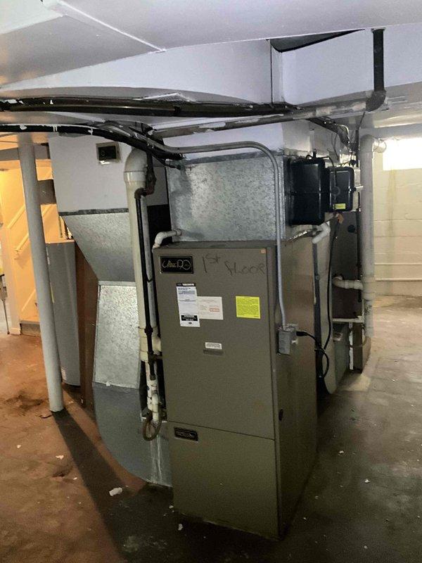Conducted comprehensive on-site evaluation for complete HVAC system replacement including both furnace and air conditioning units. Assessed existing equipment in basement mechanical room, documented current system configuration including water heater proximity, ductwork layout, and available clearances for new equipment installation. Photographed existing furnace unit with connected supply and return ductwork, insulated piping, and electrical connections to provide accurate specifications for replacement system sizing and compatibility requirements.