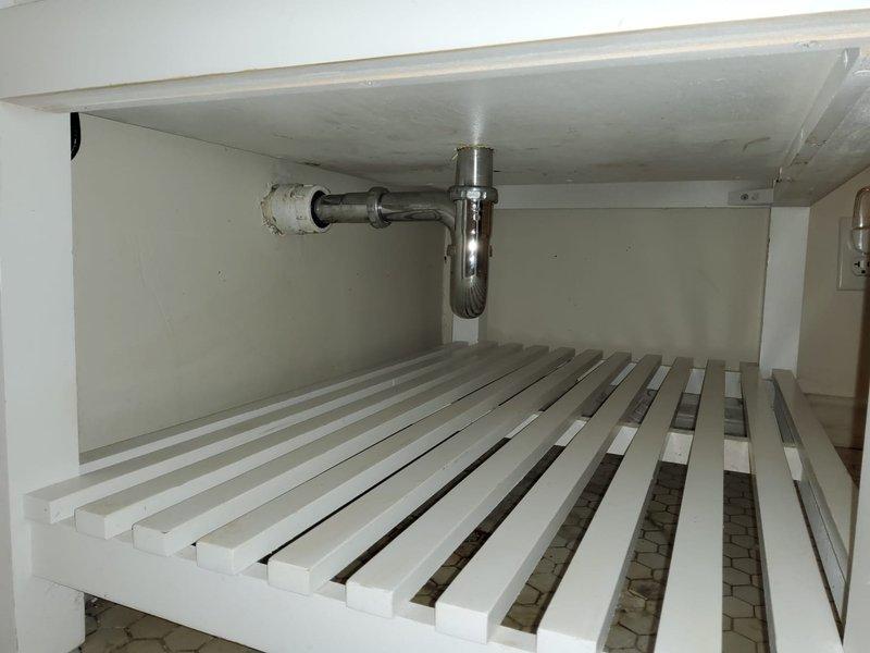 Responded to whole-home drain clog in century-old residence. Inspected plumbing system including bathroom vanity with undermount sink, chrome three-handle faucet, and P-trap assembly beneath cabinet. Cleared blockage in main drainage line to restore proper flow throughout the home. All fixtures tested and confirmed operational upon completion.