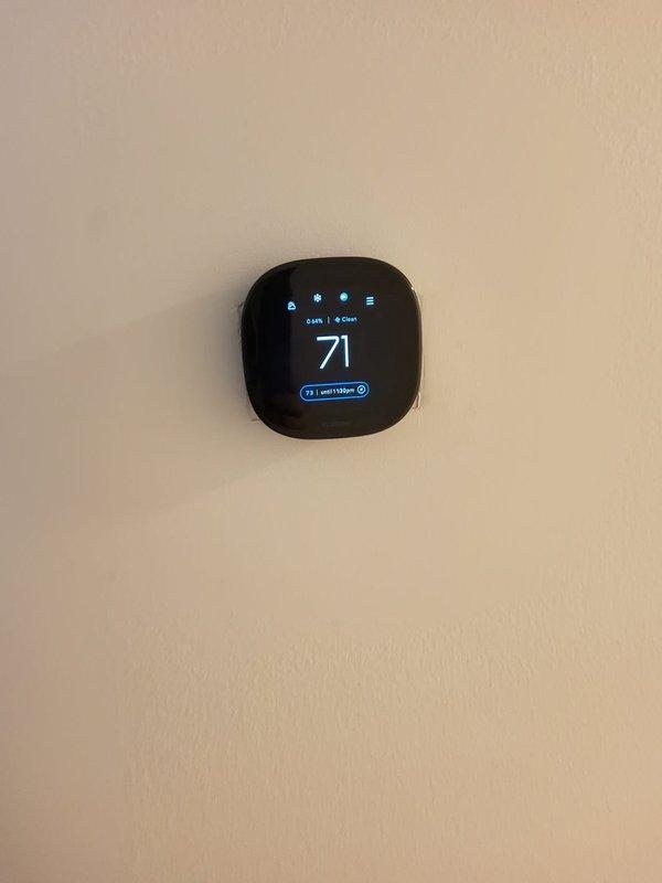Installed customer-supplied Ecobee smart thermostat on existing HVAC system with Plus 90 furnace. Thermostat was successfully mounted, wired to system, and programmed to display current temperature and schedule settings, with unit operational and communicating properly with heating equipment.