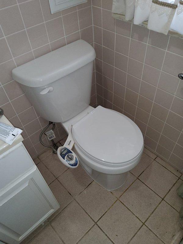 Responded to plumbing service call at a 60-year-old residential property for reported leak and clog issues. Upon arrival, conducted thorough inspection of bathroom plumbing system, focusing on toilet area and floor drainage components.

Identified significant water staining and rust buildup around floor drain, indicating chronic moisture exposure and potential drainage problems. Assessed toilet installation, water supply lines, and bidet attachment connections for signs of active leaks or deterioration. 

Cleared clog from floor drain system, removing accumulated debris and mineral deposits contributing to poor drainage and water backup. Addressed rust and corrosion issues on drain fixture, which had caused extensive staining on surrounding tile surfaces. 

Inspected all visible plumbing connections in bathroom, including toilet supply line, bidet water supply hose, and shut-off valves for proper operation and leak-free performance. Verified all fixtures were functioning correctly and 