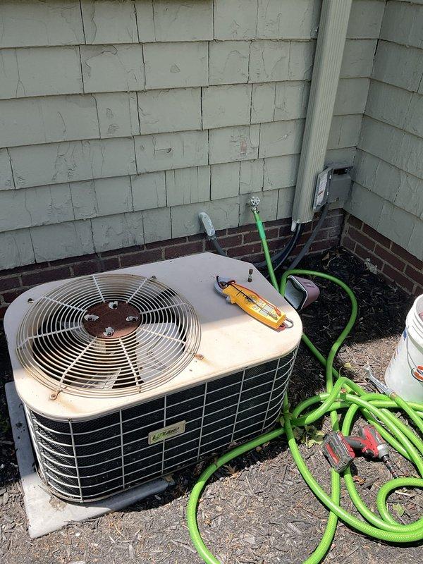 Responded to no cooling call on residential air conditioning system over 10 years old. Upon arrival, performed diagnostic evaluation of outdoor condenser unit and indoor thermostat controls. Conducted voltage testing and system assessment to determine operational status. Unit showed visible signs of age with rust and discoloration on exterior casing. Performed standard troubleshooting procedures and equipment inspection to identify cause of cooling failure on aging system.