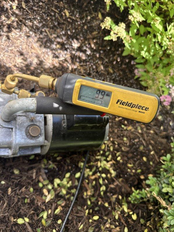 Completed full HVAC system installation at residential property. Performed system diagnostics and pressure testing using digital manometer to verify proper refrigerant pressures and airflow balance across both ports, with readings stabilized at 1.50 on P1 and P2. Repositioned outdoor air conditioning unit back onto mounting brackets per customer request and secured unit to manufacturer specifications. Conducted final system performance verification using Fieldpiece digital gauges, confirming optimal operating parameters with readings at 99 degrees, indicating proper refrigerant charge and system functionality.