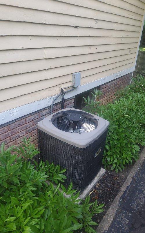 Performed initial maintenance visit on 21-year-old 8-ton air conditioning unit. Confirmed system operational status during first service call, documented equipment condition with photos showing outdoor condensing unit properly positioned on concrete pad with adequate clearance and vegetation management.