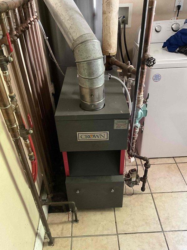 Responded to service call for older Crown boiler with active leak. Applied boiler sealer to address dripping issue as temporary measure. Assessed existing boiler system including copper piping network, expansion tank, and venting configuration. Provided replacement estimate options including standard boiler replacement and combination boiler upgrade alternatives for customer consideration.