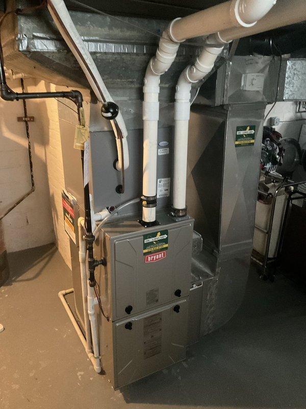 Performed comprehensive air conditioning tune-up on 3-year-old Bryant system. System evaluated and found operating properly with no issues reported by customer. Conducted standard maintenance procedures including refrigerant pressure checks using digital manifold gauges, which confirmed proper system charge and operating parameters within manufacturer specifications. Inspected outdoor condenser unit, verified clean coil fins and proper airflow. Examined indoor furnace and air handler components in basement mechanical room, checked all electrical connections, and verified proper drainage through PVC condensate lines. All system components functioning as designed with no repairs required.