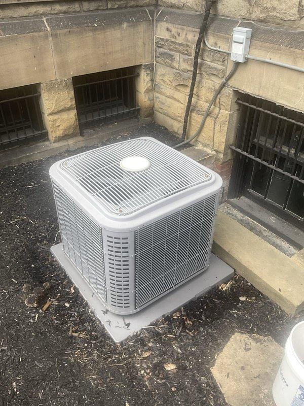 Performed comprehensive AC tune-up on outdoor condenser unit located in below-grade window well area. Completed full system inspection including electrical connections, refrigerant levels, condenser coil cleaning, and operational testing. Unit operating within normal parameters with no issues identified; all components functioning properly at time of service.