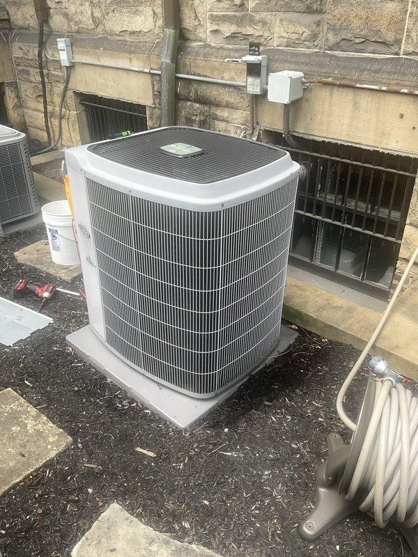 Performed comprehensive AC tune-up on outdoor condenser unit located in below-grade window well area. Completed full system inspection including electrical connections, refrigerant levels, condenser coil cleaning, and operational testing. Unit operating within normal parameters with no issues identified; all components functioning properly at time of service.