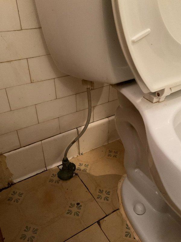 Responded to service call for toilet evaluation and replacement quote. Upon arrival, assessed existing standard two-piece white porcelain toilet with raised seat and lid. Customer requested replacement with comfort-height (ADA-compliant) toilet featuring high-flush performance capability. Inspected current installation including water supply line, shut-off valve, floor flange connection, and mounting configuration against subway-tiled wall. Documented existing floor tile pattern and spatial constraints for replacement unit specifications. Photographed current fixture and surrounding area to provide accurate measurements and installation requirements for quote preparation. Provided customer with recommendations for comfort-height toilet models with enhanced flushing systems suitable for their needs.