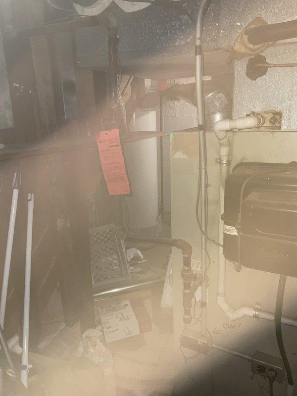 Responded to gas service shutoff due to multiple detected gas leaks in residential property. Conducted comprehensive inspection of gas system including water heater, furnace, and associated gas piping throughout basement utility area. Performed pressure testing on gas lines to identify all leak points in the system. Documentation captured showing HVAC equipment, gas-fired water heater with visible utility tag, and gas distribution piping requiring repair to restore safe gas service to the residence.