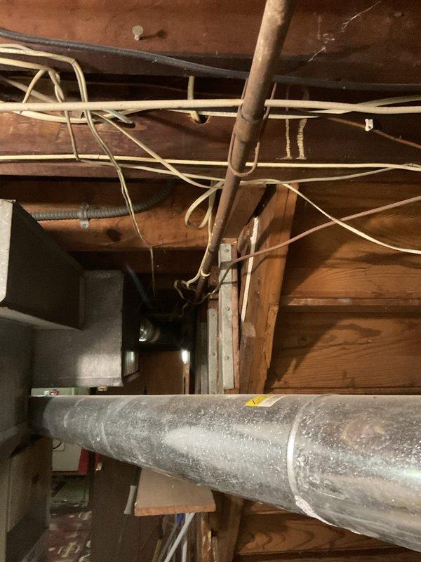 Responded to gas service shutoff due to multiple detected gas leaks in residential property. Conducted comprehensive inspection of gas system including water heater, furnace, and associated gas piping throughout basement utility area. Performed pressure testing on gas lines to identify all leak points in the system. Documentation captured showing HVAC equipment, gas-fired water heater with visible utility tag, and gas distribution piping requiring repair to restore safe gas service to the residence.