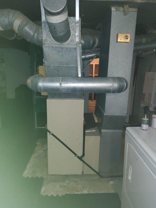 Responded to AC unit repair call and performed diagnostic evaluation of residential air conditioning system. Connected Testo 550 digital manifold gauge to outdoor condenser unit and measured refrigerant pressures and temperatures for R410A system. Recorded suction pressure of 20.19 psi with corresponding temperature of 35°F, and discharge pressure of 68.5 psi with temperature of 48°F. Inspected indoor furnace and air handler components in basement, verifying proper ductwork connections and system configuration. Documented system conditions with diagnostic photos for service records. Unit operational following assessment.