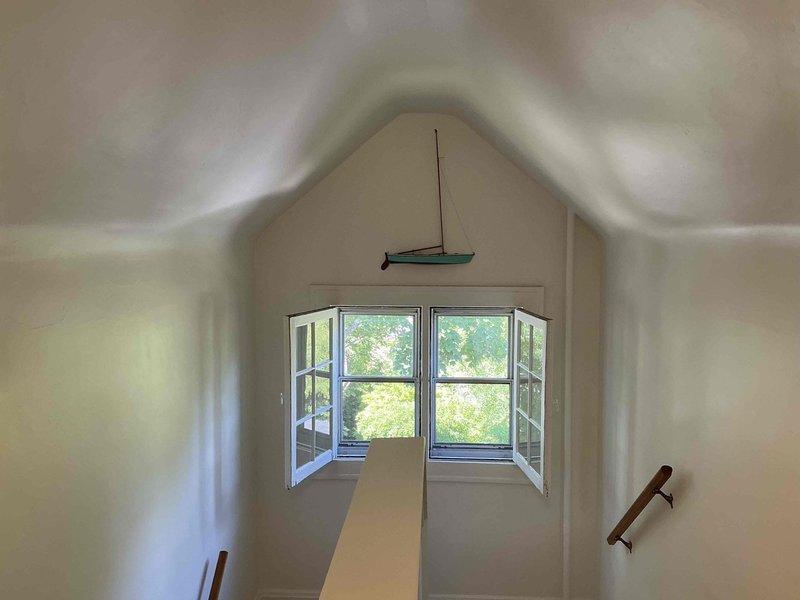 Conducted HVAC estimate for air conditioning system replacement with additional heating requirements for third-floor attic space. Assessed existing conditions including deteriorated insulation, exposed structural elements, and space constraints in converted attic area with vaulted ceiling and limited access points. Provided comprehensive replacement recommendations to address climate control needs for the upper level living space.