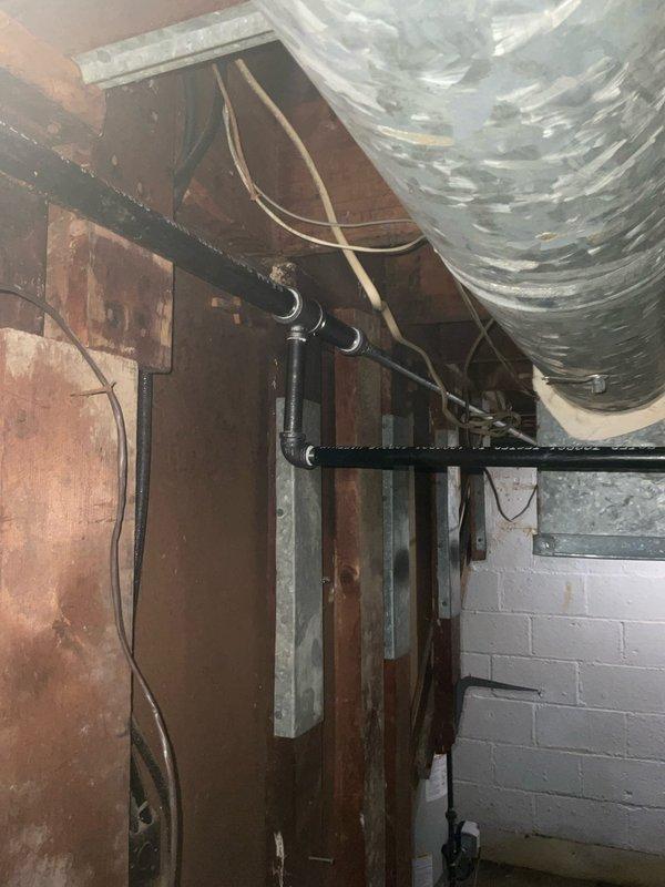 Removed and replaced old galvanized gas line from main gas supply entering the residence. Installed new gas piping with code-compliant fittings and valves to service three fixtures: furnace, hot water tank, and upstairs stove. Installed 40-gallon tall water heater with new three-quarter inch ball valve to code specifications. Repaired flue pipe to ensure proper venting and safety compliance. All work completed with helper assistance using approved materials and methods per current plumbing and gas codes.