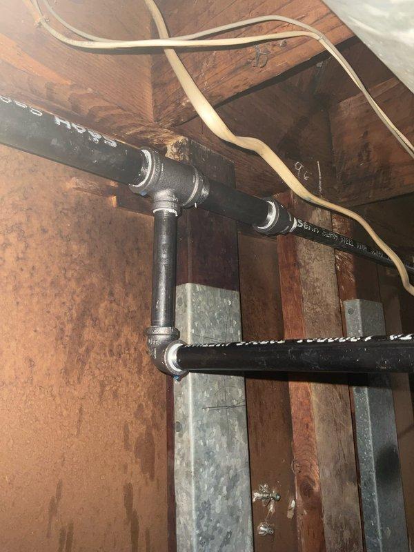 Responded to warranty call for reported gas leak in attic space. Upon arrival, performed comprehensive gas leak detection survey of exposed black iron gas piping system and associated fittings. Inspected all threaded connections, T-joints, and pipe runs utilizing electronic combustible gas detector and soap bubble solution. Identified minor leak at threaded fitting connection near main gas line distribution point. Tightened affected joint to proper torque specification and verified repair with leak detection equipment. Re-tested entire gas piping system throughout accessible areas to ensure no additional leaks present. All connections tested and confirmed secure with no further gas detection readings. System restored to safe operating condition and cleared for continued use.