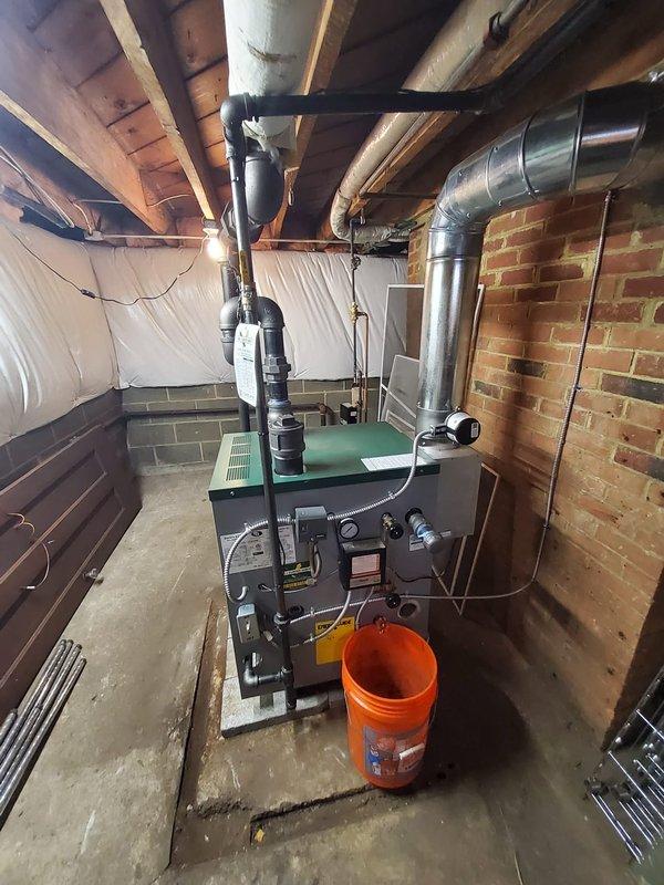 Completed full installation of Peerless Steam boiler model 63-04 in residential basement location, replacing existing heating system. Installation included mounting and connecting new boiler unit, installing automatic water feeder with backflow preventer for proper water supply protection, mounting new pressure control and low water cutoff safety devices, installing new sight glass for water level monitoring, and wiring new thermostat for system control. All steam piping connections were completed, system was pressure tested, and unit was fired and commissioned to verify proper operation of all safety controls and heating functionality.