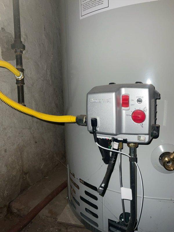 Conducted on-site consultation for tankless water heater replacement to evaluate existing 75-gallon conventional water heater system. Assessed current installation including gas supply line configuration, venting requirements, electrical connections, and available space for tankless unit conversion. Documented existing Honeywell gas control valve, flexible gas connector, and current plumbing infrastructure including copper water lines and PVC drainage system to determine compatibility and necessary modifications for tankless installation.