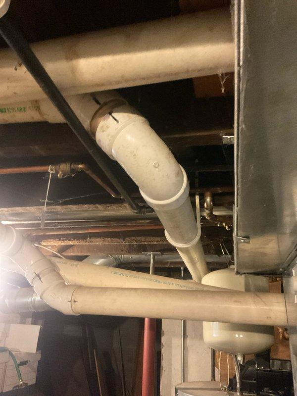 Conducted on-site consultation for tankless water heater replacement to evaluate existing 75-gallon conventional water heater system. Assessed current installation including gas supply line configuration, venting requirements, electrical connections, and available space for tankless unit conversion. Documented existing Honeywell gas control valve, flexible gas connector, and current plumbing infrastructure including copper water lines and PVC drainage system to determine compatibility and necessary modifications for tankless installation.