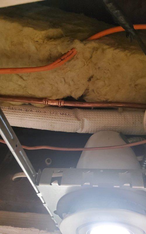 Replaced damaged sections of copper refrigerant line set that had arced due to contact with knob and tube electrical wiring in the attic space. Installed new Type L copper piping with proper insulation and secured lines with appropriate fasteners to prevent future contact with electrical components. Evacuated and recharged the system with refrigerant to manufacturer specifications, verified proper operation, and confirmed no leaks at connection points.