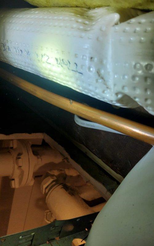 Replaced damaged sections of copper refrigerant line set that had arced due to contact with knob and tube electrical wiring in the attic space. Installed new Type L copper piping with proper insulation and secured lines with appropriate fasteners to prevent future contact with electrical components. Evacuated and recharged the system with refrigerant to manufacturer specifications, verified proper operation, and confirmed no leaks at connection points.