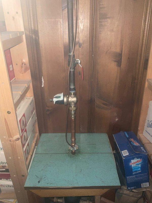 Installed Bradford White RG240T6N 40-gallon natural gas water heater with 40,000 BTU/hr capacity and atmospheric venting. Connected gas supply line using 3/4-inch threaded gas ball valve and installed motorized water pressure regulation assembly with brass valve body and automated actuator control. Configured 4-inch galvanized steel venting system with 90-degree adjustable elbow and snap-lock pipe sections to ensure proper exhaust ventilation and code compliance.