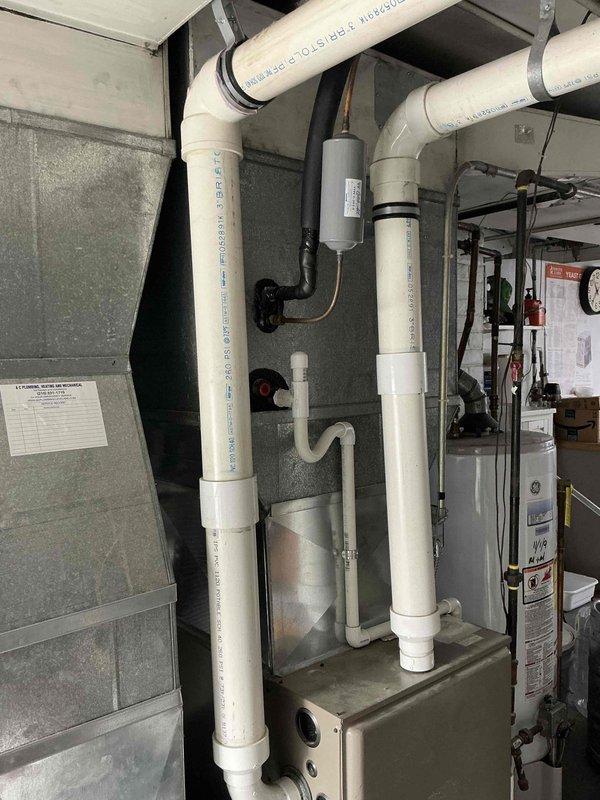 Conducted comprehensive evaluation of existing HVAC system for complete furnace and air conditioning replacement estimate. Assessed current equipment configuration including furnace unit with diamond-pattern louvered access panel, existing ductwork system, and associated PVC condensate drainage lines. Documented mechanical room layout, equipment placement, and existing infrastructure including electrical connections, gas piping, and ventilation components to determine optimal replacement specifications and installation requirements.
