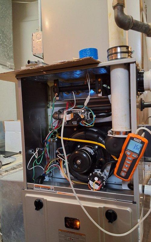 Completed full HVAC system installation including a new 90% AFUE gas furnace and 14 SEER air conditioning unit. The furnace was installed indoors with proper venting through metal ductwork, all electrical connections completed and secured, and blower motor assembly verified operational. The outdoor condensing unit was positioned on a polymer base pad in a gravel bed with concrete paver edging, refrigerant lines and electrical conduit run along exterior wall and properly connected. Both units were tested with diagnostic equipment to confirm proper operation, all safety controls verified functional, and system startup completed successfully.