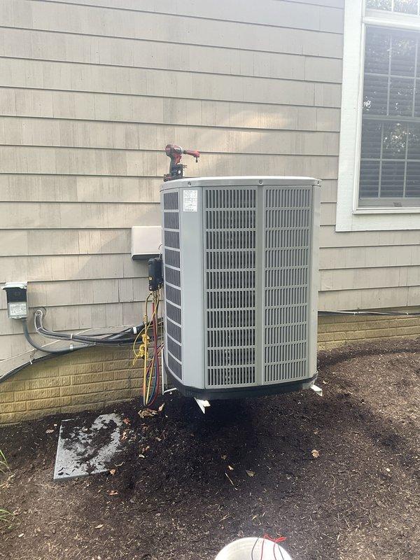 Completed preventative maintenance tune-up on residential air conditioning system. Performed system diagnostics using refrigerant manifold gauges to verify proper operating pressures and temperatures across the condenser unit. All measured parameters were within acceptable ranges, and the outdoor unit was found to be functioning properly with adequate airflow through the vertical grille sections.