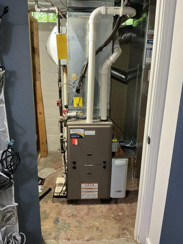 Conducted comprehensive on-site assessment of existing HVAC system for replacement estimate. Evaluated 25+ year-old air conditioning unit currently non-operational and approximately 12-year-old furnace installation in basement mechanical room. Documented existing equipment configuration including beige furnace unit with white PVC venting system, copper plumbing connections with shut-off valves, metal ductwork, and associated mechanical components. Photographed current system layout, piping arrangements, and equipment placement on concrete floor against cinder block walls to facilitate accurate replacement planning and equipment sizing recommendations.