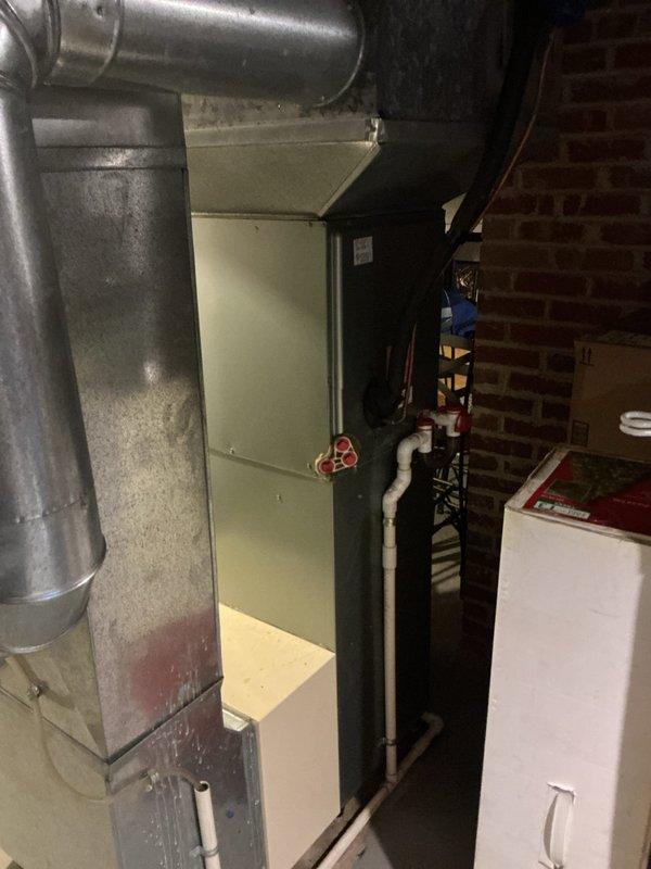 Conducted comprehensive evaluation of residential HVAC system in response to air conditioning malfunction with blower operational but no cooling output. Assessed aging equipment estimated from 1980s era, including furnace and condensing unit, to provide replacement recommendations. Documented existing basement mechanical room configuration, including current ductwork connections, PVC venting system, gas piping with shutoff valve, and clearance requirements for new equipment installation.