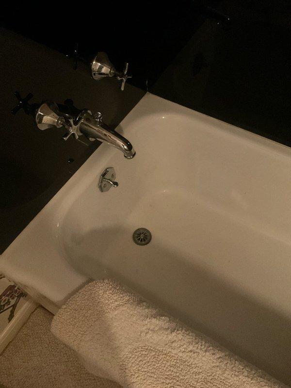 Responded to service call for multiple slow-draining fixtures throughout the residence. Performed comprehensive diagnostic inspection of all drains as requested, including bathtub, sink, and other plumbing fixtures. Inspected bathtub drain and surrounding plumbing system, noting chrome fixtures and drain assembly in working condition. Assessed drainage flow rates and identified areas requiring mechanical cleaning. Snaked affected drain lines to remove buildup and restore proper water flow. Verified all drains were functioning correctly before departure, ensuring complete system performance throughout the property.