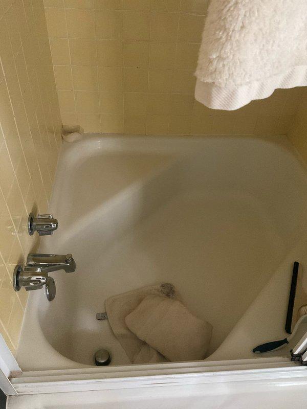 Responded to service call for multiple slow-draining fixtures throughout the residence. Performed comprehensive diagnostic inspection of all drains as requested, including bathtub, sink, and other plumbing fixtures. Inspected bathtub drain and surrounding plumbing system, noting chrome fixtures and drain assembly in working condition. Assessed drainage flow rates and identified areas requiring mechanical cleaning. Snaked affected drain lines to remove buildup and restore proper water flow. Verified all drains were functioning correctly before departure, ensuring complete system performance throughout the property.