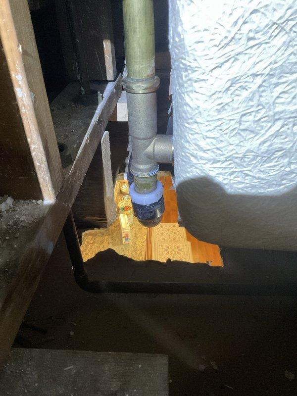 Completed tub drain repair requiring extensive access work. Removed cabinet adjacent to shower and created access openings in wall and ceiling below to reach drain assembly. Cut opening in wall to expose framing and plumbing infrastructure, allowing proper access to drainage system. Opened ceiling from below to facilitate repair of bathtub drain connections. Installed new drain fittings and piping, including valve assembly with protective drip pan positioned beneath connections. All waivers obtained prior to commencing demolition work. Restored plumbing system to proper working order.
