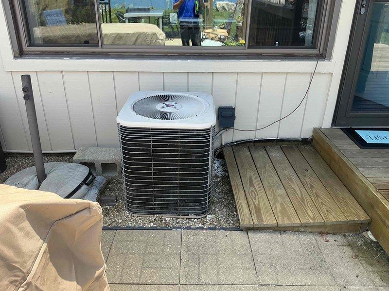Provided comprehensive estimate for complete HVAC system replacement of aging 19+ year old furnace and air conditioning equipment. Evaluated existing basement-installed furnace with associated ductwork, humidifier, and outdoor condenser unit positioned on concrete pad against exterior wall. Assessed current system configuration including galvanized metal ductwork, copper refrigerant lines, PVC condensate drainage, and electrical disconnect components to determine replacement specifications and installation requirements for new high-efficiency heating and cooling system.