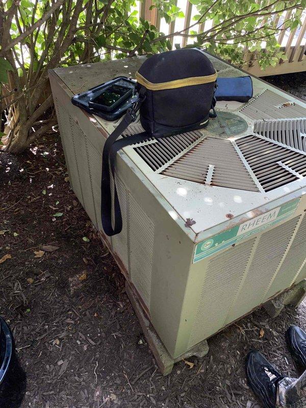 Responded to no cooling call affecting entire residence. Upon arrival, found 40-year-old outdoor air conditioning condenser unit in severely deteriorated condition. Performed visual inspection of exterior unit, noting extensive age-related wear, discoloration, and debris accumulation on condenser coils and housing. Documented unit condition with photographs showing significant staining on louvers and compromised system components. Given the unit's age well beyond typical equipment lifespan of 15-20 years, advised customer that repair would not be cost-effective and recommended full system replacement. Unit has exceeded manufacturer's intended service life by more than two decades and shows multiple signs of end-of-life failure.