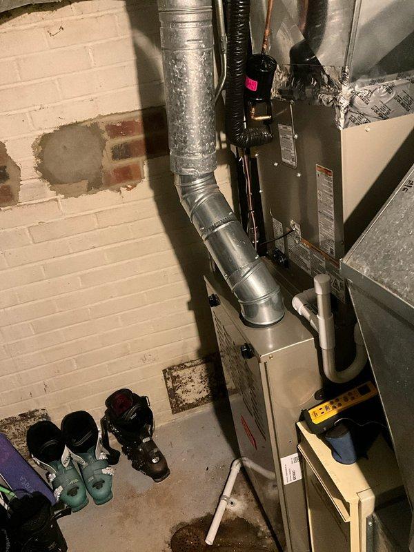 # Complete HVAC System Replacement

Replaced two complete HVAC systems including furnace units and air conditioning condensers. Installed new Bryant furnace equipment in basement mechanical room with proper venting and ductwork connections. Fabricated and connected new metal ductwork to integrate with existing distribution system. 

Removed existing humidifier units from both systems and patched all affected ductwork sections to maintain proper airflow and system integrity. Installed new copper refrigerant linesets for both air conditioning systems, running lines from indoor coils to outdoor condensing units. 

Set new outdoor condenser units on freshly installed equipment pads. Reconnected all electrical connections using new disconnect switches at both indoor and outdoor equipment locations to meet current electrical code requirements. Integrated Space-Gard air filtration system into ductwork for improved indoor air quality.

Reused existing thermostat controls, verifying proper comm
