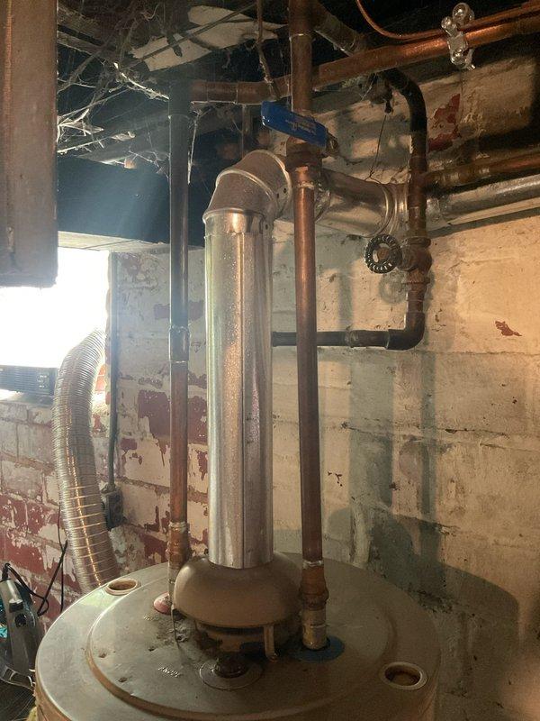 Responded to emergency call for failed 24-year-old A.O. Smith ProMax water heater that was actively leaking and had flooded the basement. Upon arrival, assessed the extent of water damage and confirmed the unit had reached end of service life with catastrophic tank failure. Shut off water supply and drained remaining water from the failed unit. Disconnected all copper supply and discharge piping, removed old water heater from basement utility room, and disposed of failed equipment. Installed new replacement tanked water heater with proper connections to existing copper plumbing infrastructure, including hot and cold water lines and temperature/pressure relief valve discharge piping. Verified all connections for proper sealing, restored water supply, filled tank, and tested unit operation to ensure proper heating function and no leaks. System returned to full operational status with no further water intrusion.