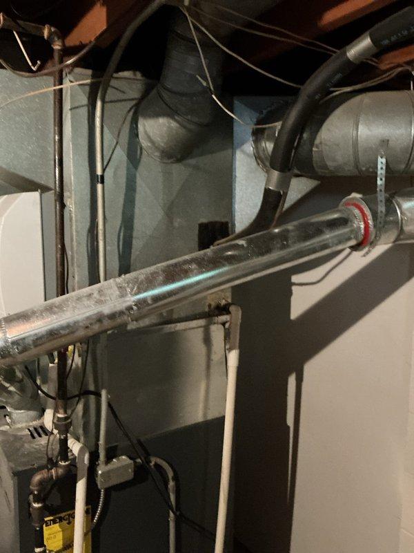 Responded to service call for non-functional air conditioning system affecting entire residence. Upon arrival, evaluated 40-year-old outdoor AC unit that had reached end of serviceable life. Conducted comprehensive system assessment including inspection of existing furnace, ductwork, and associated HVAC components in mechanical room. Documented current equipment configuration including furnace unit with connected humidifier, metallic ductwork with visible age-related wear and dust accumulation, and existing copper refrigerant lines. Photographed installation showing gray metal heating equipment, black insulated refrigerant lines with flexible connections, brass valve fittings, and silver metallic duct system. Prepared detailed estimate for complete air conditioning system replacement given the advanced age of equipment and failure to operate, recommending modern energy-efficient replacement unit to restore cooling functionality to the home.