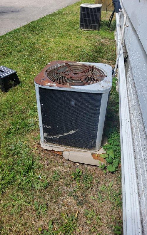 Responded to no cooling complaint affecting entire residence with 26-year-old home and aging HVAC system. Upon arrival, inspected outdoor condensing unit which exhibited significant rust deterioration on top panel and fan grill assembly, indicating unit was likely original equipment and well beyond expected service life. Evaluated indoor Carrier WeatherMaker furnace and associated ductwork in basement mechanical room, confirming system configuration and verifying air handler operation. Documented equipment condition showing extensive weathering and corrosion on outdoor unit components. Advised customer that aging air conditioning system requires replacement due to deteriorated condition and age-related failure, as unit has exceeded manufacturer's expected lifespan and repair would not be cost-effective given the extent of component degradation observed.