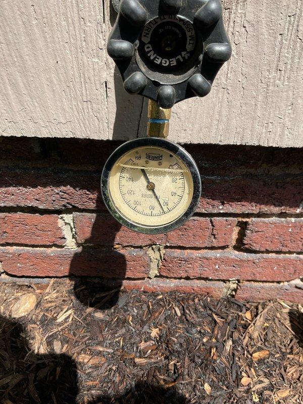 Responded to service call for malfunctioning valve causing restricted water flow and retrieved quick-connect hose left behind from previous AC service. Conducted thorough inspection of plumbing system including utility sink area and exterior hose bib assembly. Evaluated pressure gauge readings at both interior copper pipe manifold and outdoor spigot to diagnose flow restriction issue. Inspected valve operation, brass fittings, and connection points for potential blockages or mechanical failure. Documented existing conditions including pressure measurements and valve functionality through photographic evidence for service records.