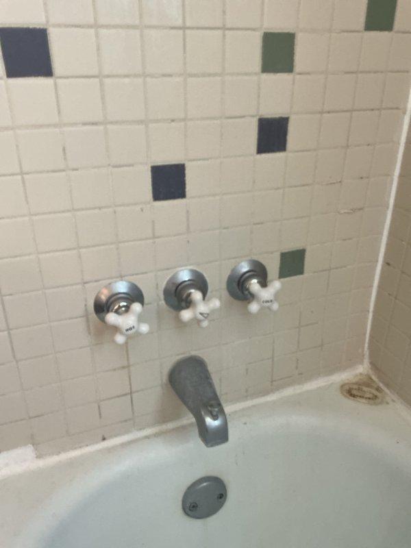 Replaced both the three-handle tub and shower valve assembly and the single-handle tub and shower valve with new chrome fixtures. The installation included new escutcheon plates and trim, restoring proper water control and diverter function to the bathtub plumbing system.
