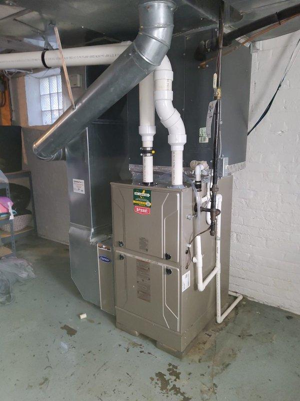 Responded to service call for excessive condensation affecting entire home on 5-year-old Bryant HVAC system, model CAP4860D6BA. Upon inspection, documented system configuration including furnace unit, air handler, and associated PVC venting system in basement mechanical room. Evaluated condensate drainage components and verified proper system operation to identify source of moisture issue throughout residence.