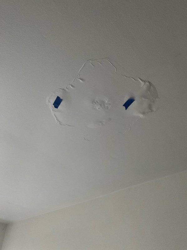 Responded to shower drain repair call at 80-year-old residential property. Upon investigation, identified water damage and drainage issues requiring access through ceiling below the shower area. Performed ceiling access work to reach plumbing infrastructure, including removal and repair of drywall section. Inspected plumbing lines, ductwork, and surrounding insulation in confined crawlspace area above affected bathroom. Addressed drainage concern and completed ceiling patch repair with drywall compound. Documented condition of mechanical systems and insulation during repair process.