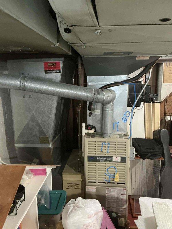 Completed HVAC system replacement estimate for residential property where existing WeatherMaker 8000 furnace and outdoor condensing unit are undersized due to home addition. Assessed current equipment capacity, measured ductwork configuration in basement mechanical room, and evaluated outdoor unit placement against brick exterior. Recommended properly sized replacement system to accommodate increased square footage and ensure adequate heating and cooling capacity for expanded living space.