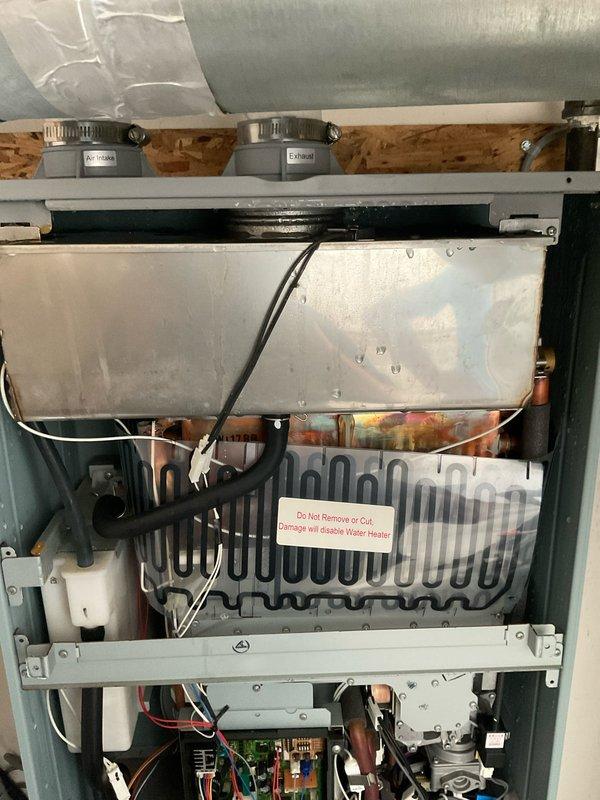 Responded to service call for Rheem RTGH-95DVLN-2 tankless water heater with sensor alert and no hot water production. Inspected internal components including heat exchanger assembly, electrical connections, control board, and venting system. Diagnosed sensor malfunction, performed necessary repairs to restore unit functionality, and verified proper operation of all system components including gas valve, ignition system, and water flow.