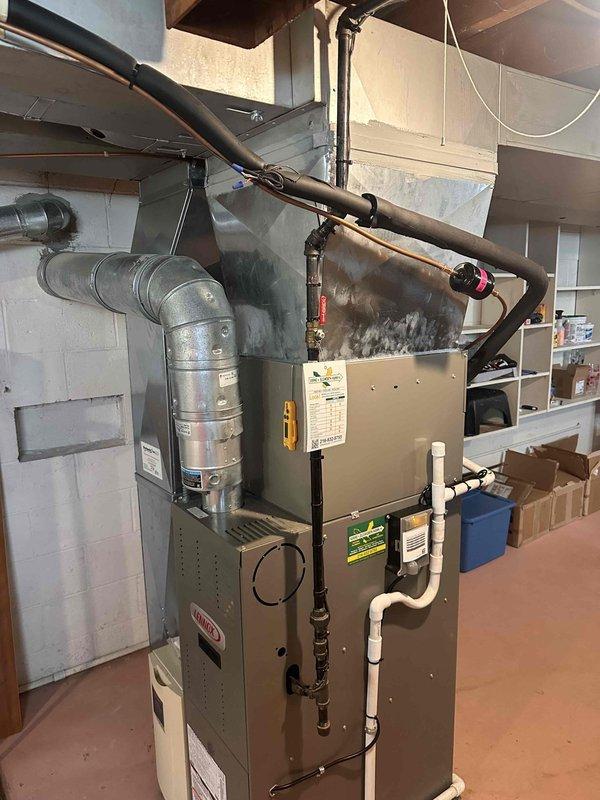 Completed full Bryant air conditioning system installation including new indoor evaporator coil mounted to existing furnace, outdoor condensing unit positioned on new equipment pad, electrical disconnect box for code compliance, and programmable thermostat for enhanced temperature control. All refrigerant lines were properly sized and insulated, electrical connections were made per manufacturer specifications, and system was tested for proper operation and cooling performance. Installation includes 10-year parts warranty and 1-year labor warranty.